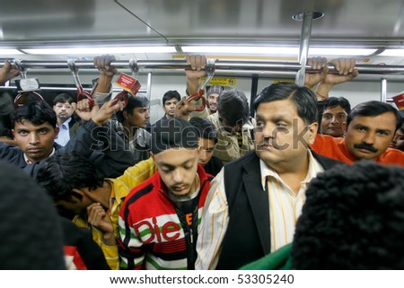 DELHI - JANUARY 19: Men standing in a crowded train carriage  on January 19, 2008 in Delhi, India. Nearly 1 million passengers use the metro daily.