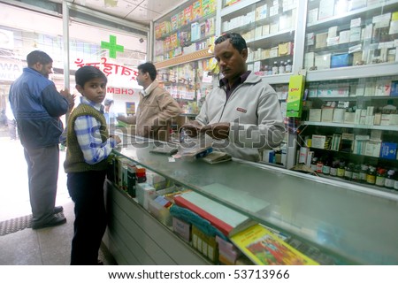 DELHI - FEB 2008. Pharmacy assistant selling medicine to customers on February 12, 2008 in Delhi, India. 80% of medicine revenue comes from international markets and just 20% from India.