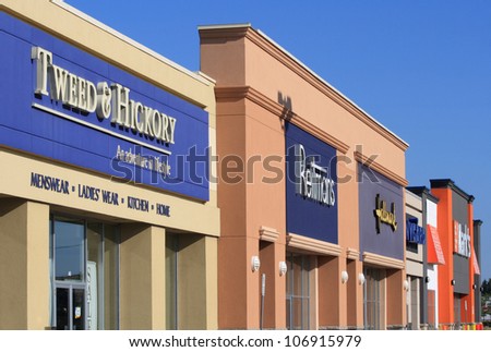 OTTAWA, CANADA - JULY 2: A row of store fronts in Barrhaven, which is part of Ottawa, Ontario. It is the fastest growing neighbourhood in Ottawa, with many new stores being built recently.