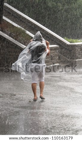 OTTAWA, CANADA - AUGUST 5: A woman walking in the rain at the Ottawa Locks during the    annual Rideau Canal Festival on August 5, 2012 in Ottawa, Ontario. The canal is a UNESCO World Heritage Site.