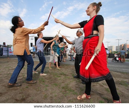 OTTAWA, CANADA - AUGUST 11: People learning Dandiya at the Festival of India on August 11, 2012 in Ottawa, Ontario. Dandiya is an Indian dance where participants bang sticks together to music.
