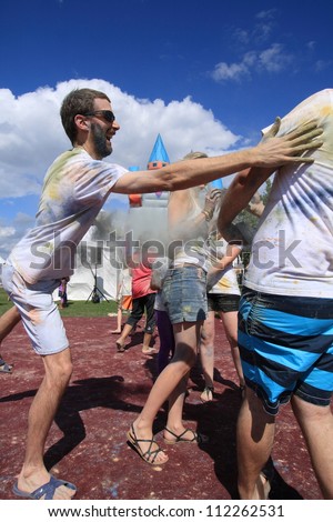 OTTAWA, CANADA - AUGUST 11: People playing during a holi celebration at the Festival of India on August 11, 2012 in Ottawa, Ontario. Holi is like a game of tag but uses colored powders and water.
