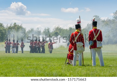 MORRISBURG, CANADA - JULY 14: Men doing battle during the Battle of Crysler\'s Farm reenactment on July 14, 2013 near Morrisburg, Ontario.