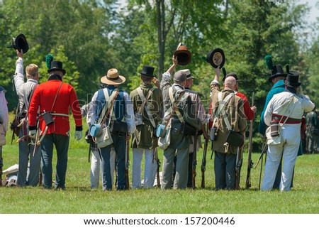 MORRISBURG, CANADA - JULY 14: Men celebrate victory during the Battle of Crysler's Farm reenactment on July 14, 2013 near Morrisburg, Ontario.