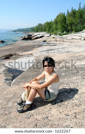 Filipino woman hiking coast of Lake Superior. Lake Superior Provincial Park, Ontario.