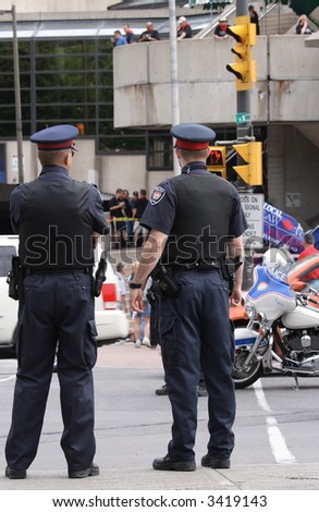 Policemen watching rally over Canadian job losses. Ottawa, Ontario. Canada.