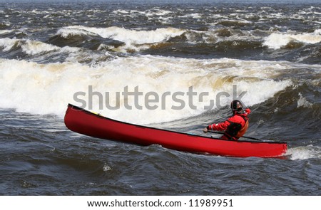 A man canoeing in the Champlain Rapids of the Ottawa River at Bates Island. Ottawa, Ontario. Canada.