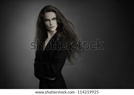 Fashion model portrait. Woman brunette with long thick hair