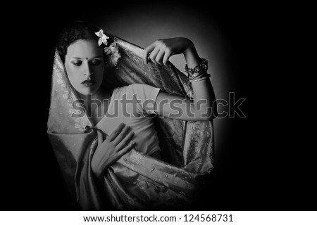 Woman in Indian fashion dark romantic portrait in black and white