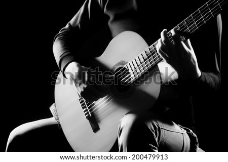 Acoustic guitar music instrument classical guitar in guitarist hands closeup