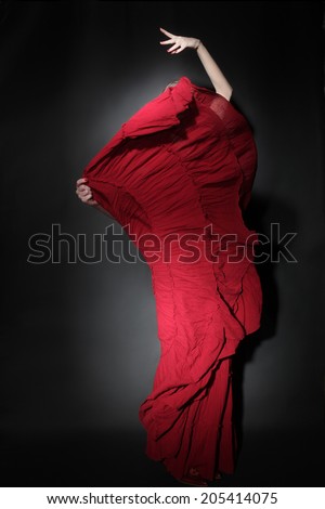 Flamenco dancer in red dress. Woman dancing in long flying dress