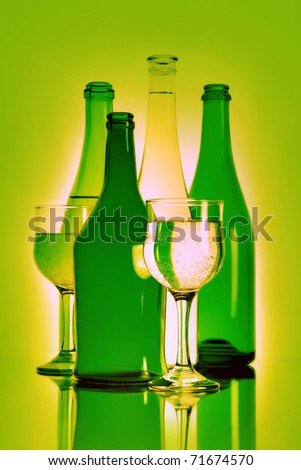 Bottle and wineglass. Green still-life with beverage in bottles and wineglasses