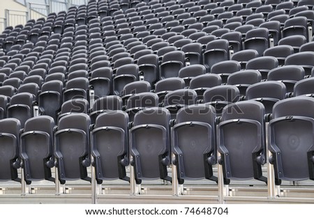 Rows of chairs on an outdoor stage.