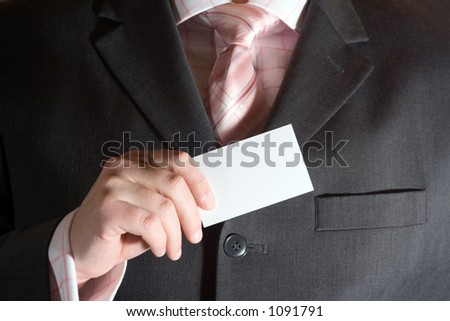 A businessman holding a blank business card