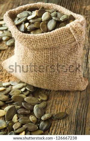 Pumpkin seeds in small burlap bag
