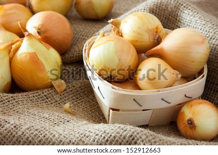 Onions in small basket. agriculture background