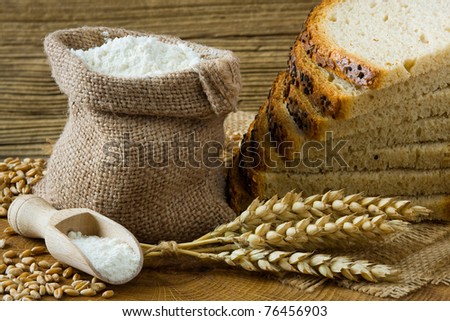 Fresh homemade bread and flour in small burlap bag