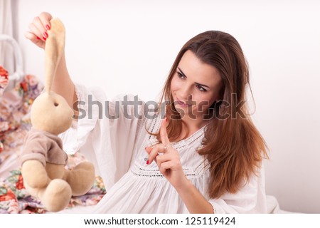 A girl holding a stuffed toy rabbit