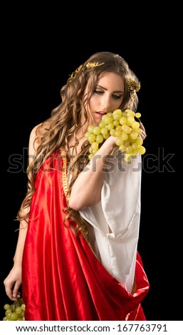Ancient godness with a bunch of grapes isolated on a black background