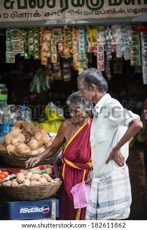 MADURAI, INDIA-FEBRUARY 15: Trader on the street of Indian town on February 15, 2013 in Madurai, India. Trader on a city street province Tamil Nadu
