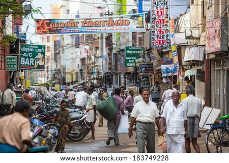 MADURAI, INDIA-FEBRUARY 15: Street of Indian city 15, 2013 in Madurai, India. People on the street of indian town