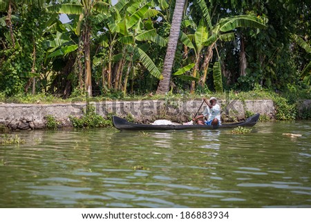KOCHIN, INDIA-FEBRUARY 23: Hindu on the boat on February 23, 2013 in Kochin, India. Hindu man go by boat suburb of Cochin
