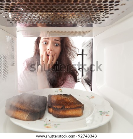 Young girl burned toasts in a microwave