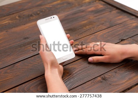 Mobile phone in the hands of a girl with a blank screen