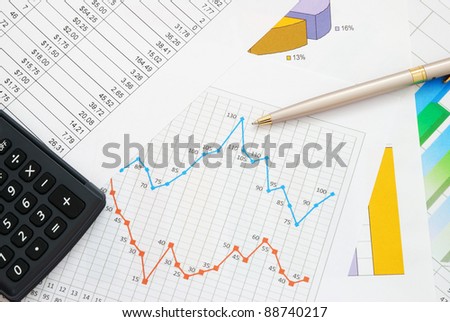 Finance documents with pen and calculator