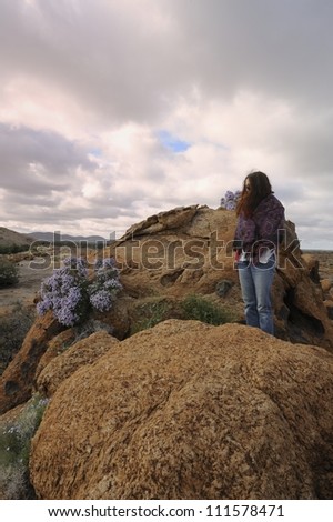 Tourist atop a granite outcrop at Augrabies National Park, Northern Cape, South Africa