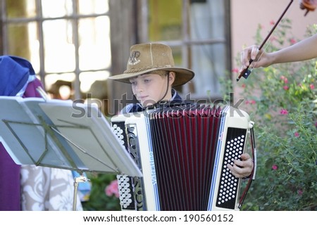 HIMEVILLE, SOUTH AFRICA - APRIL 26: Young musicians busking at a   morning country fair on April 26, 2014, in Himeville, a popular tourism destination,  Drakensberg, Kwazulu Natal, South Africa .