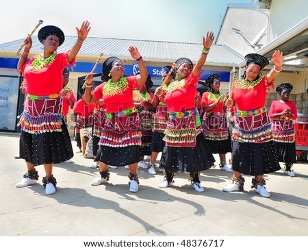 UNDERBERG - FEBRUARY 13: Zulu Dancers. Women from  a low-cost housing project busk at a mall, entertaining Saturday morning shoppers on February 13, 2010 in Underberg, South Africa.