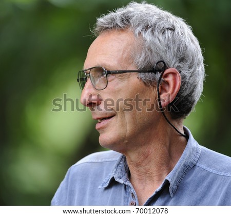 profile of old man with silver hair and glasses