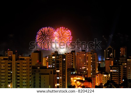 Fireworks behind the buildings in the city .