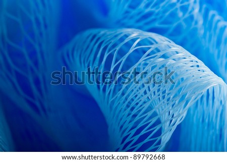 Abstract macro photo of massage blue bath sponge.