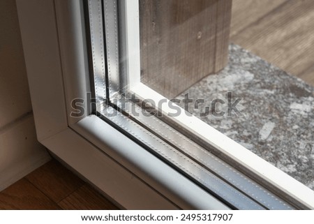 Similar – Image, Stock Photo The window panes of a gymnasium reflect the neighboring buildings and a street tree, all in bright blue and sunshine.