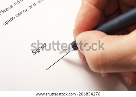 male hand signing a contract