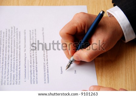 male hand keeping an elegant pen and signing a contract