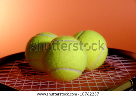 three yellow tennis balls and racket