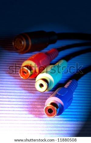 red green blue video cable connectors over a rugged surface with spotlight effect