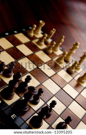angled view of a chess board with all the pieces ready to start the game