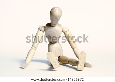 artist\'s mannequin sitting on a white floor