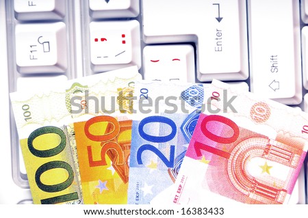 euro banknotes on a keyboard, concept for electronic business, banking and shopping