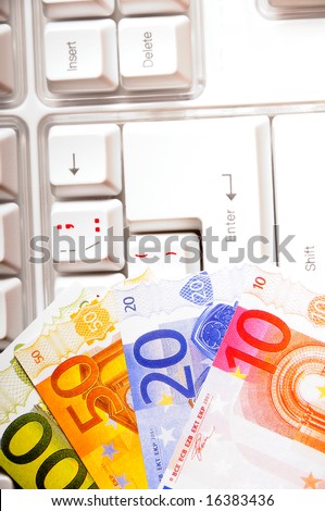euro banknotes on a keyboard, concept for electronic business, banking and shopping