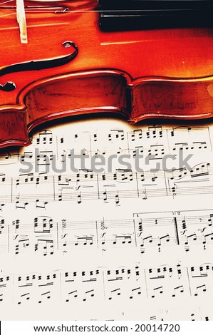 detail of a classical violin on a music sheet