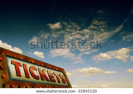 ticket sign with light bulbs against a blue sky with lot of copy space