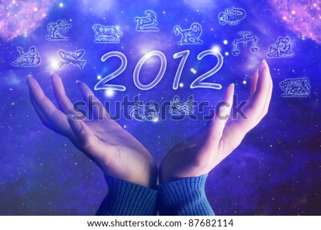 hands of  a woman over background with Universe, 2012 and zodiac symbols