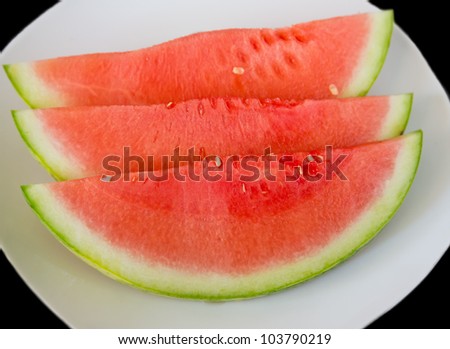watermelon slices closeup over plate with black background