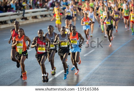 VALENCIA - NOVEMBER 18: Kipiyego (number 16) leads the group with other runners at first meters of the marathon, in Valencias marathon on November 18, 2012 in Valencia, Spain