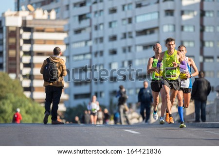 VALENCIA - NOVEMBER 17: Juan Matias Ojeda Montesdeoca (number 193) leads his group durint his participation in Valencias marathon on November 17, 2013 in Valencia, Spain